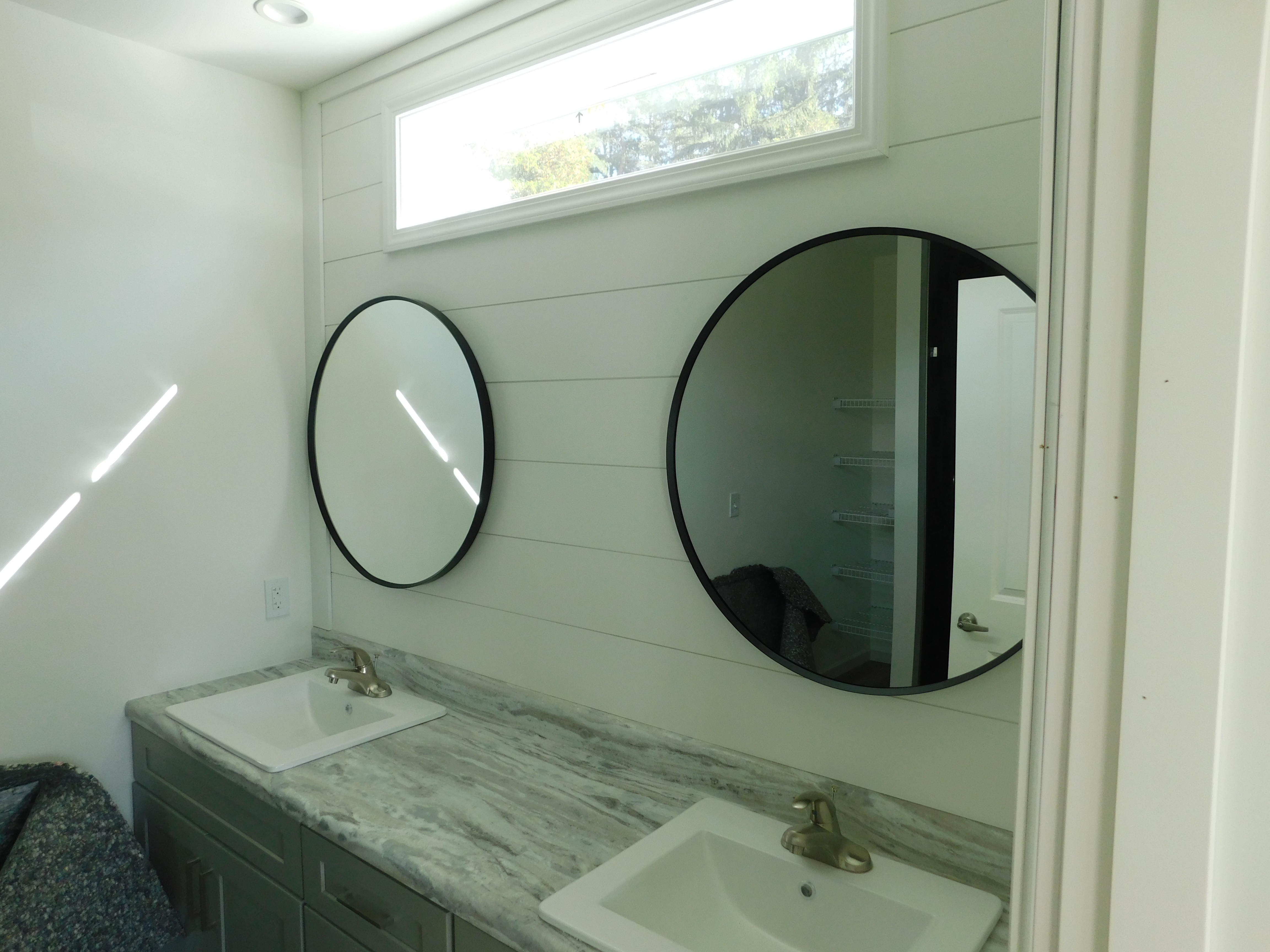 Transom windows over mirrors